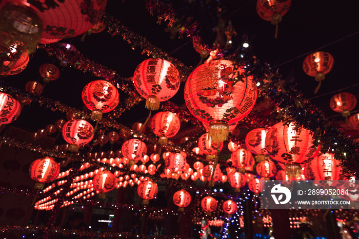 Red Chinese lantern(Translation Hieroglyph text Happy New Year) hanging in a row during day time for Chinese new year celebration.