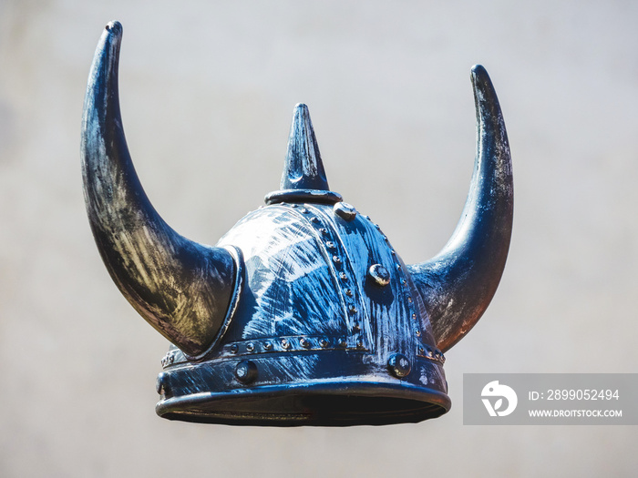 Helmet of medieval warrior on gray background, knightly helmet with horns_