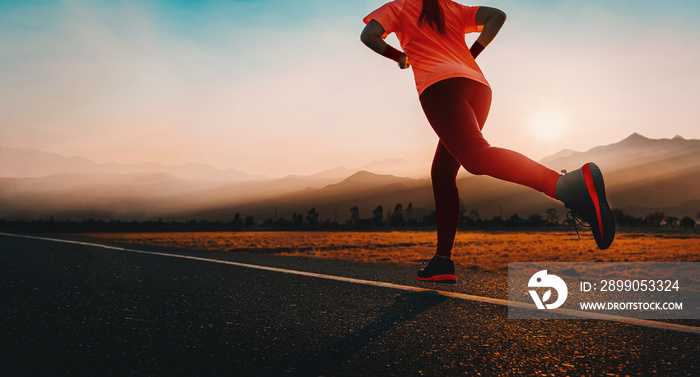 Woman enjoys running outside with beautiful summer evening in the countryside.