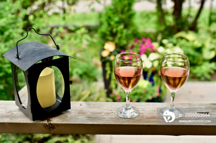 Outdoor oasis setting in secluded backyard deck at summer vacation rental in lush, luxury setting for relaxing with wine in beautiful landscaped garden