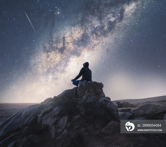 person meditating at night under the Milky Way