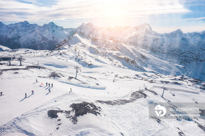 Cabin window view of people skiing in winter resort - Holidays, extreme sport gear renting, snowboarding and mountain landscape concept - Focus on ski snow track