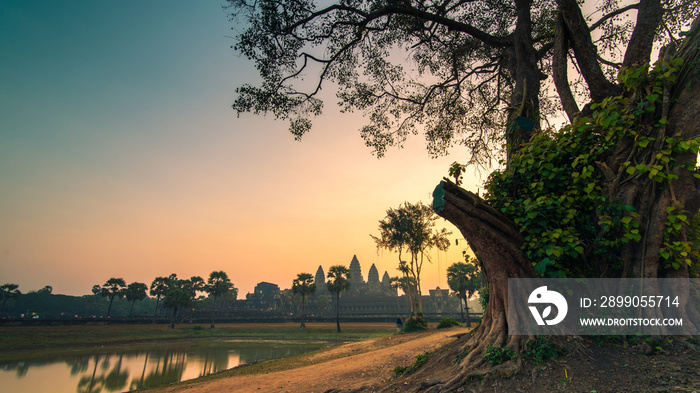 Sunrise view of popular tourist attraction ancient temple complex Angkor Wat with reflected in lake Siem Reap, Cambodia