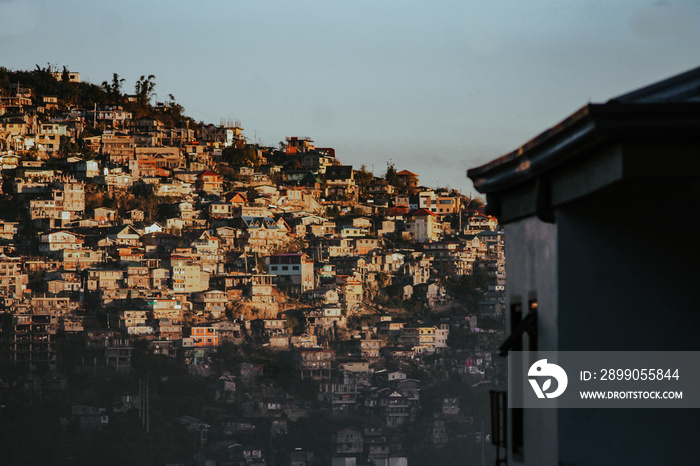 Golden light from the sunrise washing over Baguio City in the highlands of Philippines