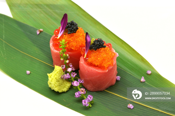 Otoro roll special (caviar roe, salmon roe, maguro, otoro) in white plate on white background