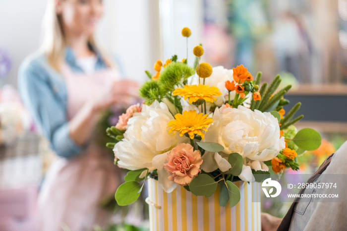 close-up view of beautiful floral bouquet in striped box at flower shop