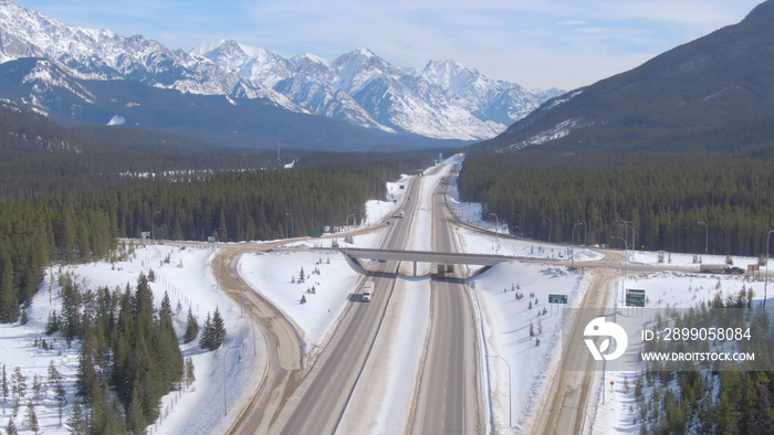 AERIAL: Trucks haul cargo down the Trans Canada Highway on sunny winter day