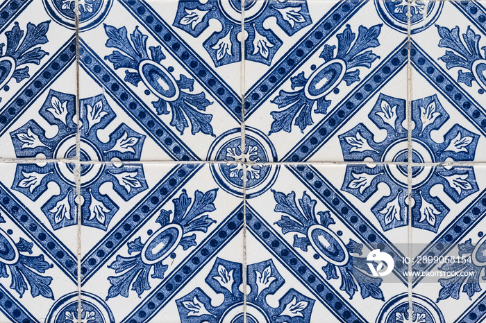 Azulejos in Portugal, detail on a typical house, blue background