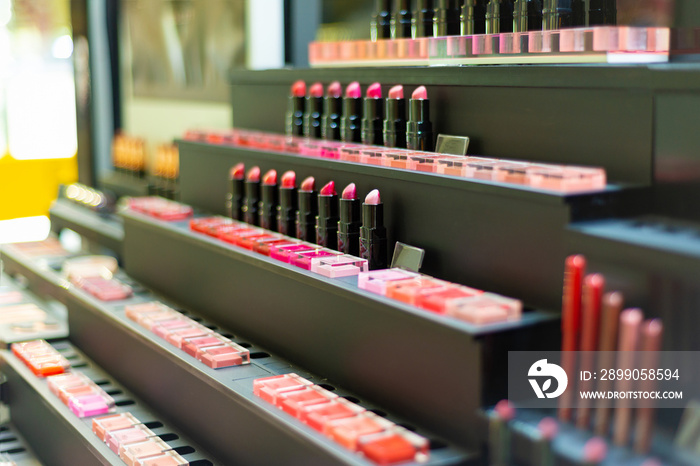 Exhibition of cosmetics in a boutique, lipstick on sale in a store. Colorful and gorgeous colors for professional makeup.