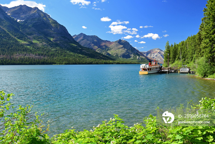 an incredible view in summer  from  goat haunt, glacier national park  of the mountains, water,  and forests of waterton lakes national park in alberta, canada