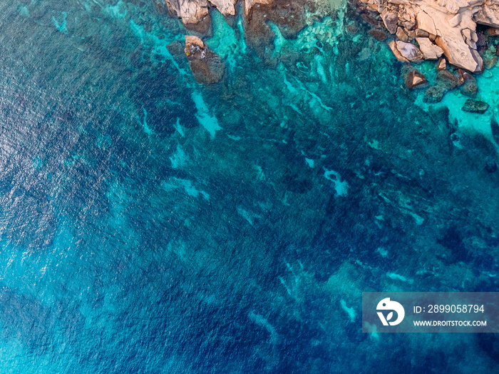 Mediterranean Sea with turquoise water beats on coast of island of Malta. Aerial top view