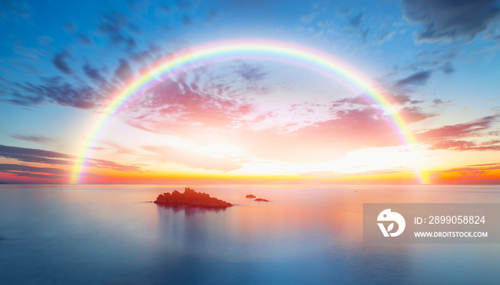 Beautiful landscape with turquoise sea with double sided rainbow at sunset