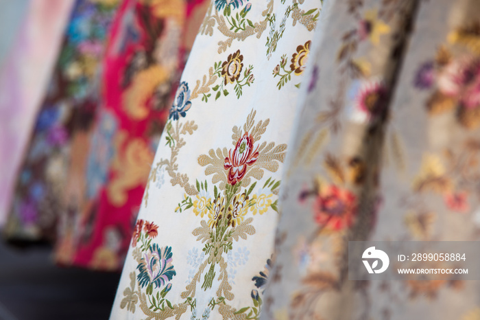 Detail of the typical dress of the fallas of Valencia. Close up photograph focused on one of the skirts with floral motifs.