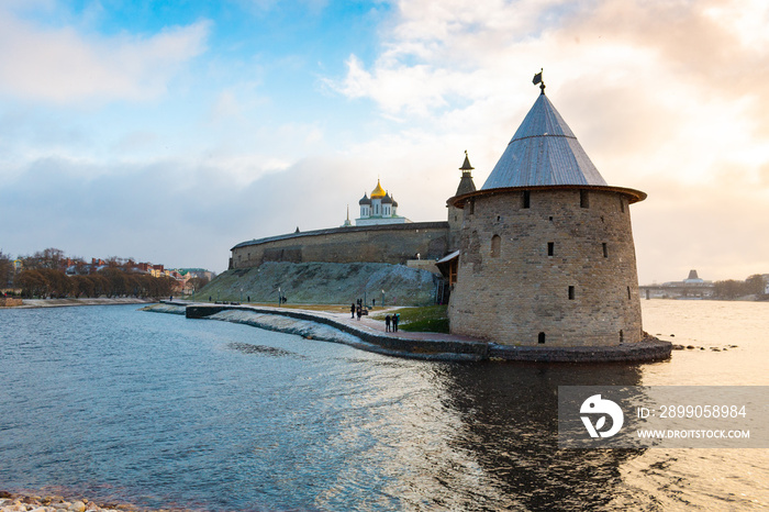 One of the main sightseeing in Pskov city - Ploskaya tower of Pskov Kremlin (also Pskov Krom) and the promenade of Pskova river and Velikaya river. Troitsky church and Kremlin walls on the background