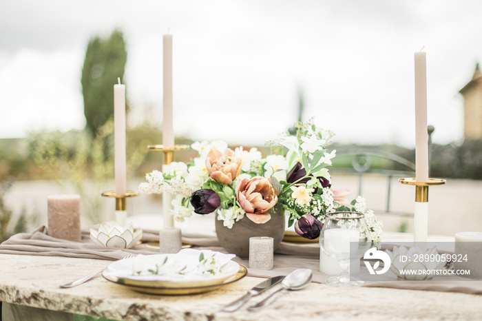 Romantic dinning table in backyard, decorated with flowers for intimate wedding