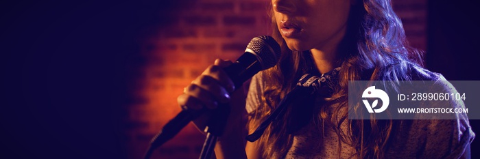 Female singer looking away while performing