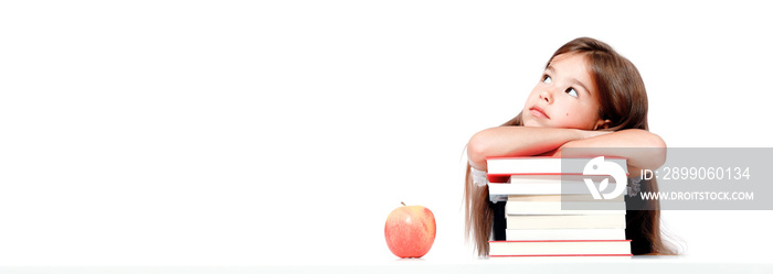 Cute little child girl looking up on the desk at school.