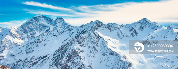 Snowy blue mountains in clouds. Winter ski resort