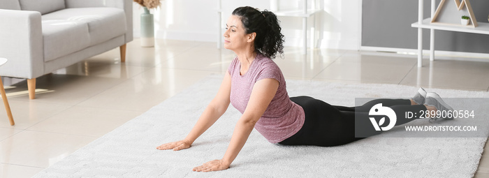 Sporty woman practicing yoga at home