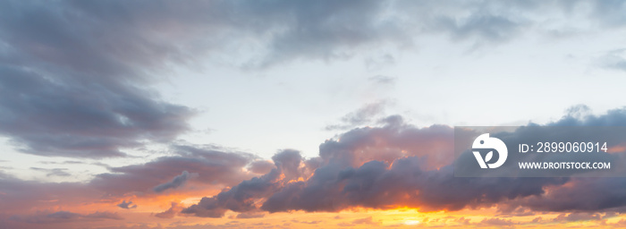 Dark clouds and shining sun at dusk