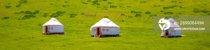 Yurt. National ancient house of the peoples of Kazakhstan and Asian countries. National Housing. Yurts on the background of a green meadow and highlands.