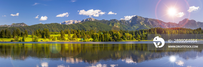 beautiful rural landscape in Bavaria with mountain range and meadow at springtime