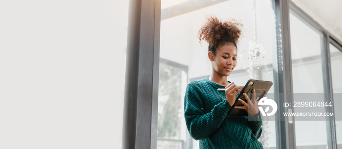 Confident female african american university student portrait study online with tablet and mobile smartphones with video conferencing education application