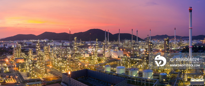 Aerial view drone of oil storage tank with oil refinery factory industrial. Oil refinery plant at beautiful sky sunset and twilight. industry factory concept and transportation.