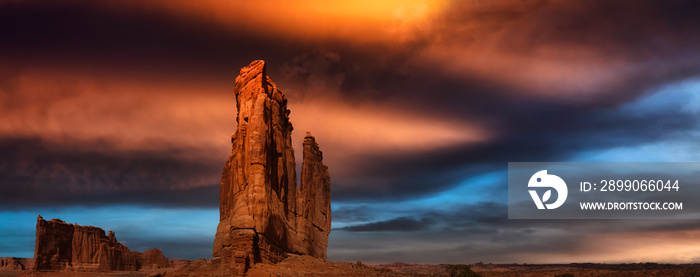 Landscape view of beautiful red rock canyon formations. Dramatic Colorful Sunset Artistic Render. Taken in Arches National Park, located near Moab, Utah, United States.