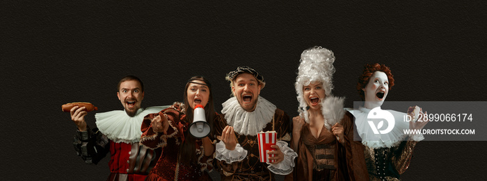 Cheering, screaming, eating. Medieval people as a royalty persons in vintage clothing on dark background. Concept of comparison of eras, modernity and renaissance, baroque style. Creative collage.