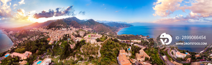 Taormina, Sicily Italy panoramic drone photo sunset, volcano Etna in clouds. Aerial top view