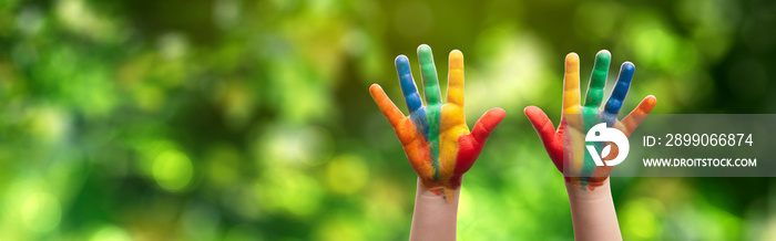 panoramic - child with painted hands in the park