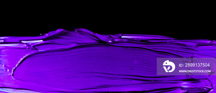 Purple neon paint brush stroke texture isolated on black background