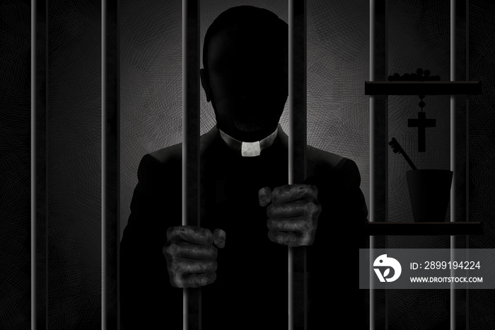 A Catholic priest identified by his clergyman collar is seen in silhouette behind bars with his filt