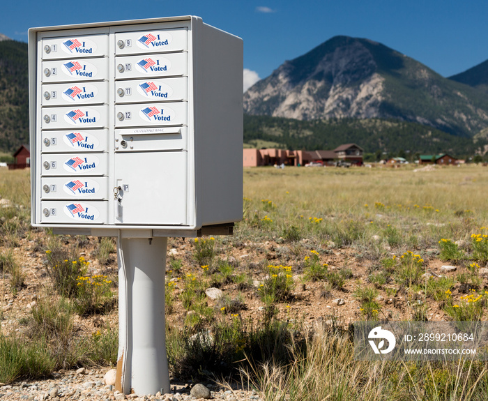 Metal mailbox container for rural homes with I Voted stickers as concept for voting by mail or absentee ballot paper