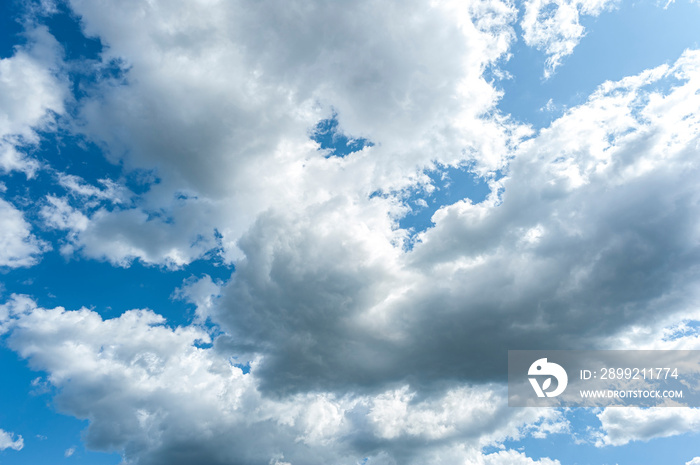 Dark clouds of cold front forming in blue sky.