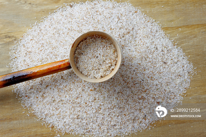 portion of raw psyllium husk over rustic wooden table