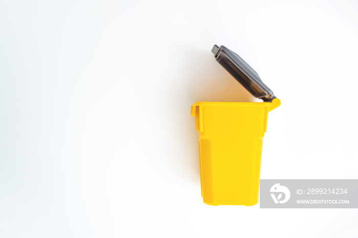 Mini yellow trash on the white screen isolated