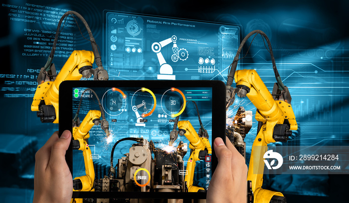 Engineer controls robotic arms by augmented reality industry technology application software. Smart robot machine in future factory working in concept of Industry 4.0 or 4th industrial revolution.