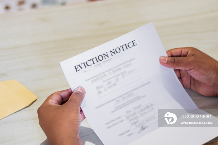 Hands of a man holds eviction notice letter