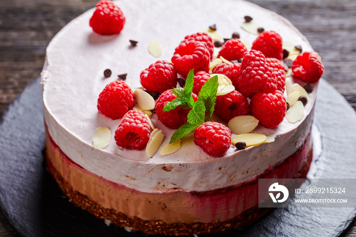 raspberry mousse cake on a slate black plate