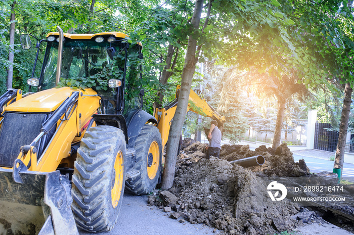 working excavator tractor digging a trench for pipenline