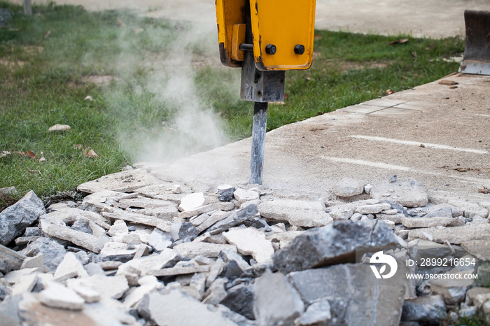 Drilling vehicle breaking concrete in road