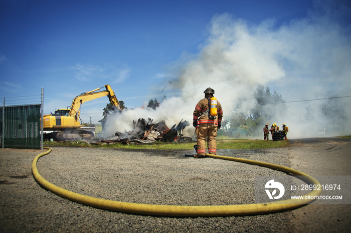 Firefighters spraying water to stop fire