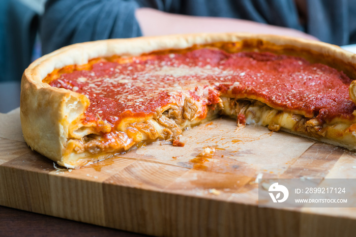 Top view of Chicago pizza. Chicago style deep dish italian cheese pizza with tomato sauce and beef meet inside