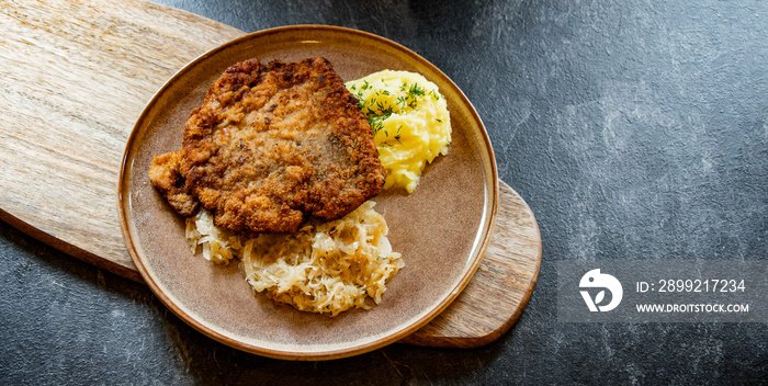 Pork breaded cutlet coated with breadcrumbs with mashed potatoes