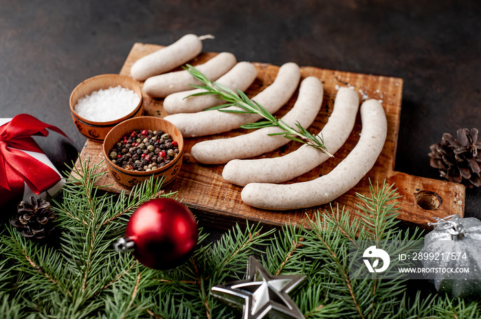 Christmas sausages on a background of stone with branches Christmas trees, toys, gifts