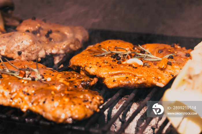 meat with  herbs grilling on barbecue