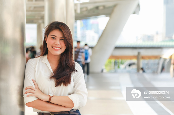 Portrait of young charming Asian businesswoman cross her arm with smile on face
