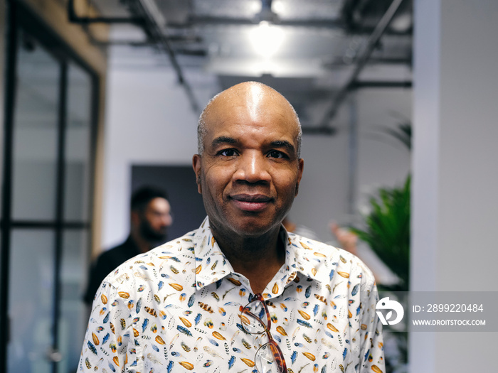 Portrait of man in office hallway